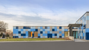 Front exterior of small art museum with colorful tile siding